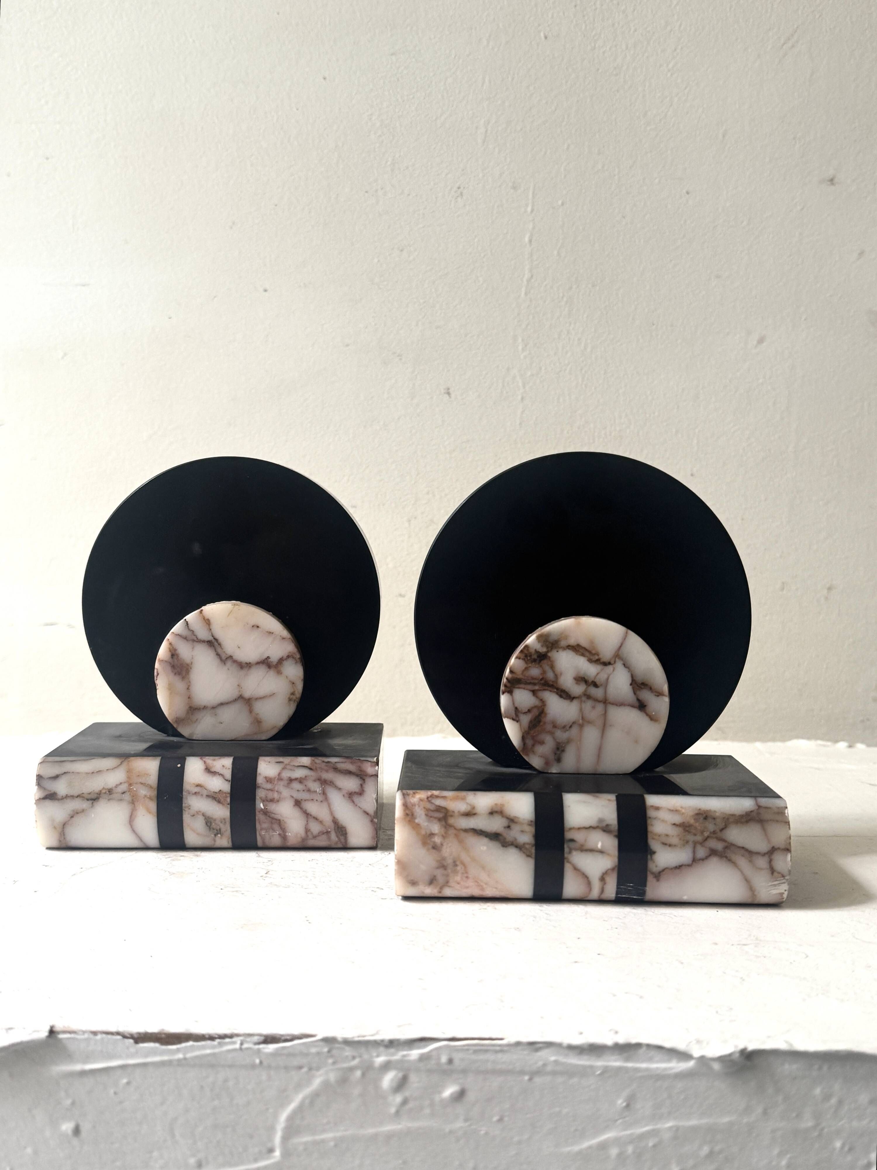 Art Deco bookends with a circular design in black and pink marble.