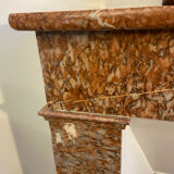 Marble fireplace surround with closed hearth frame.