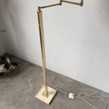 Floor lamp with articulated arm in brass-plated metal