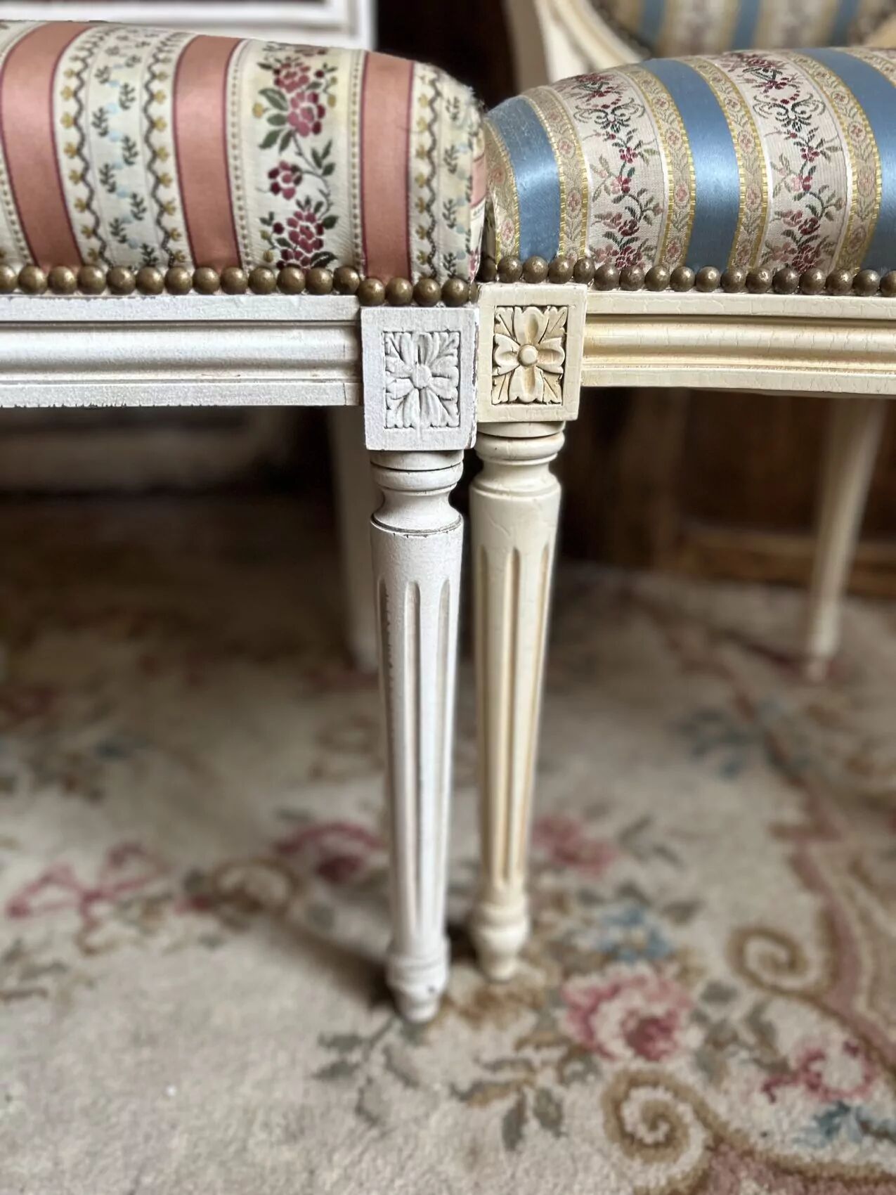 Pair of Louis XVI style chairs in painted wood and satin, classic elegance.