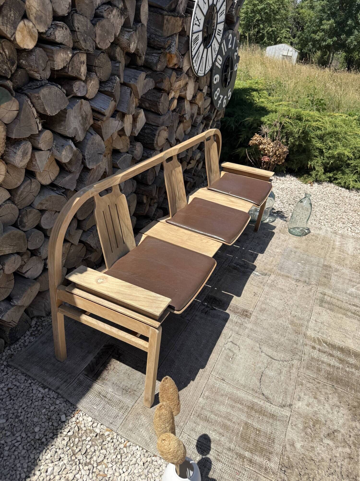 Baumann bench with wooden frame and faux leather seat.