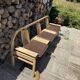 Baumann bench with wooden frame and faux leather seat.