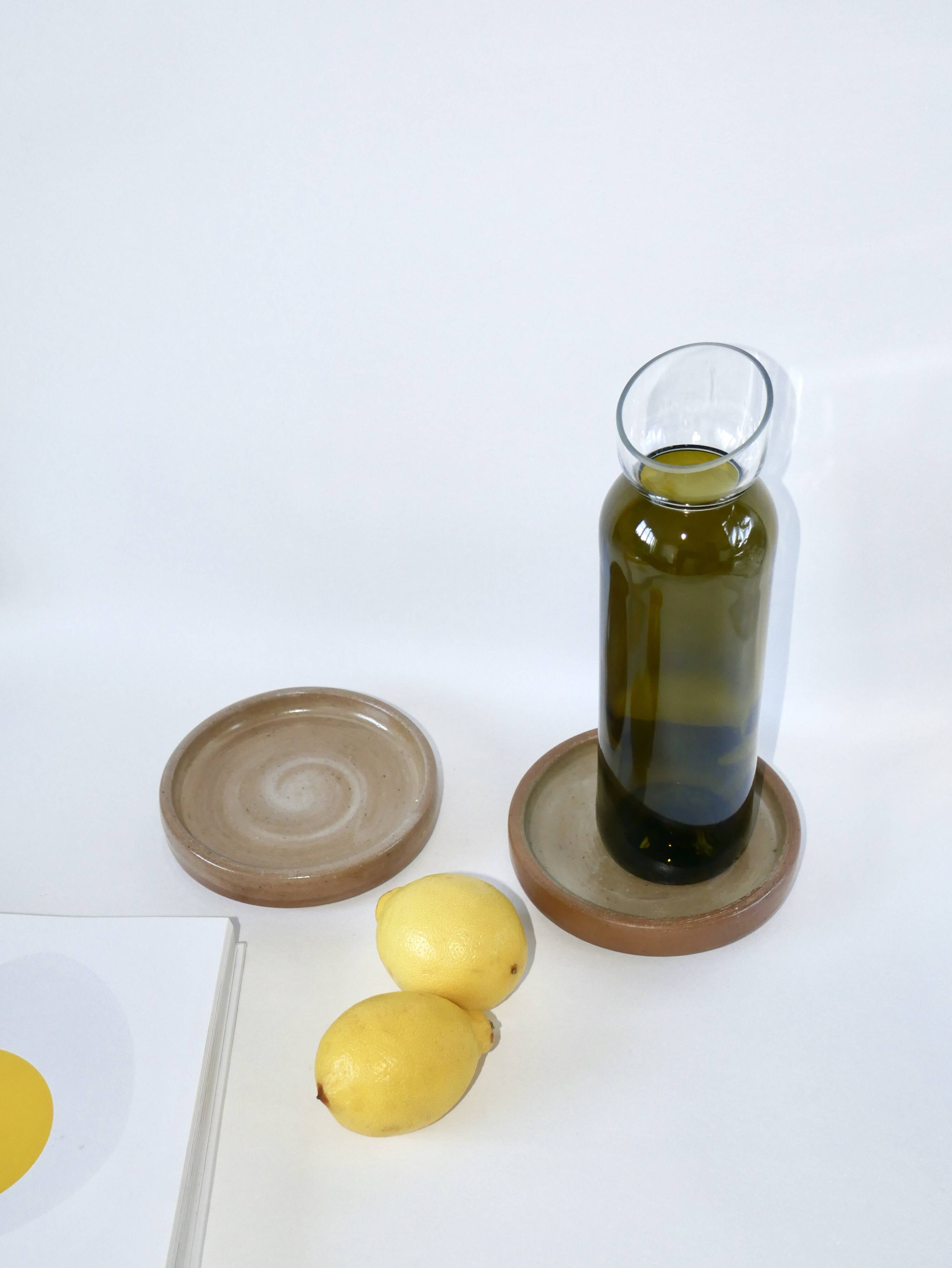 Pair of enamelled stoneware bottle coasters 1970