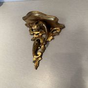 Antique wall-mounted console in gilded wood in rococo style.