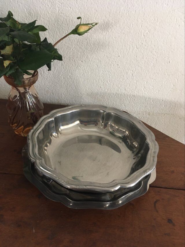 Two matching round dishes in stainless steel