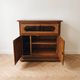 Rustic wooden TV unit with a swivel top and moulded doors.