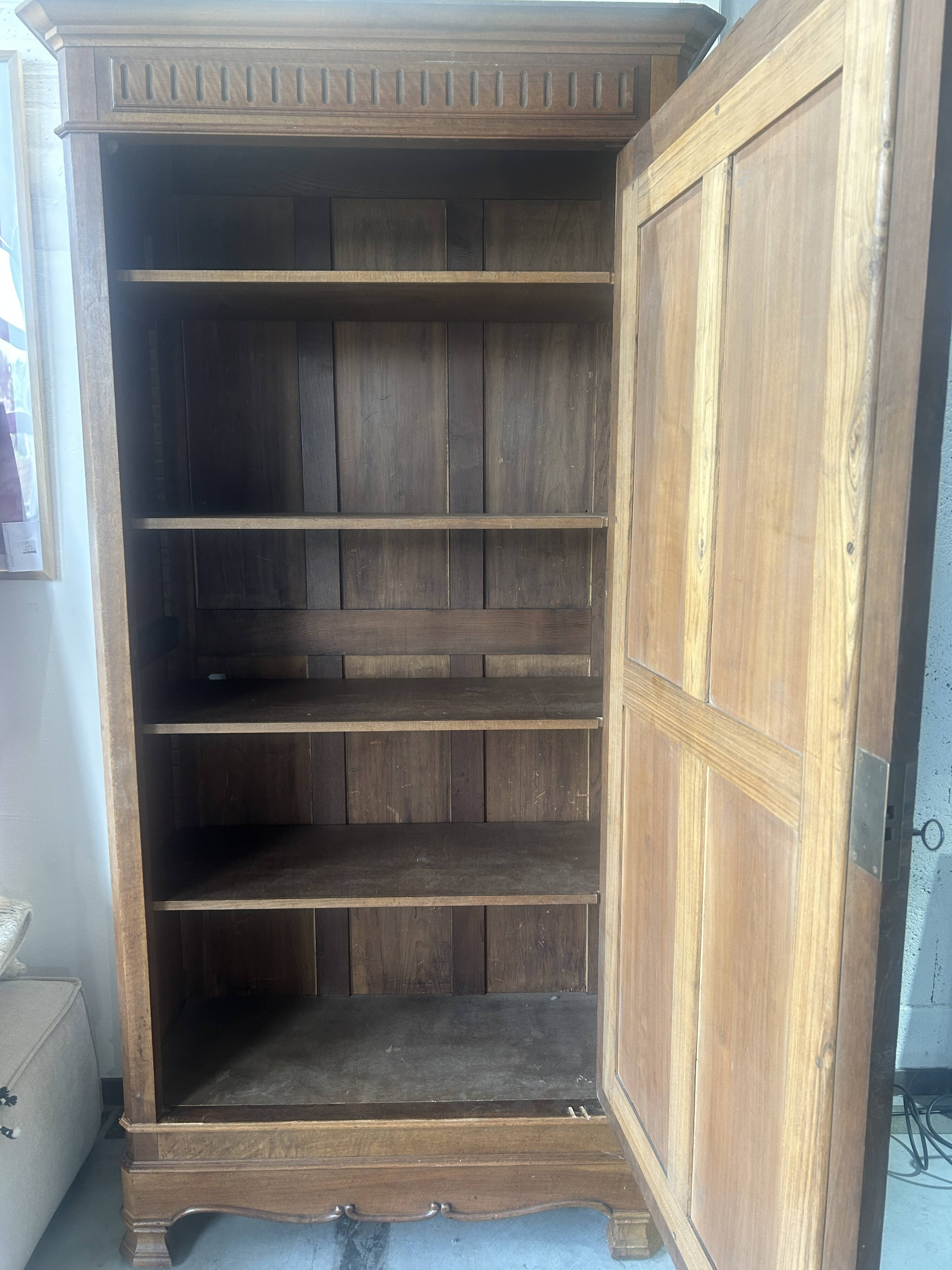 Antique Louis-Philippe walnut veneered wardrobe with an antique mirror.