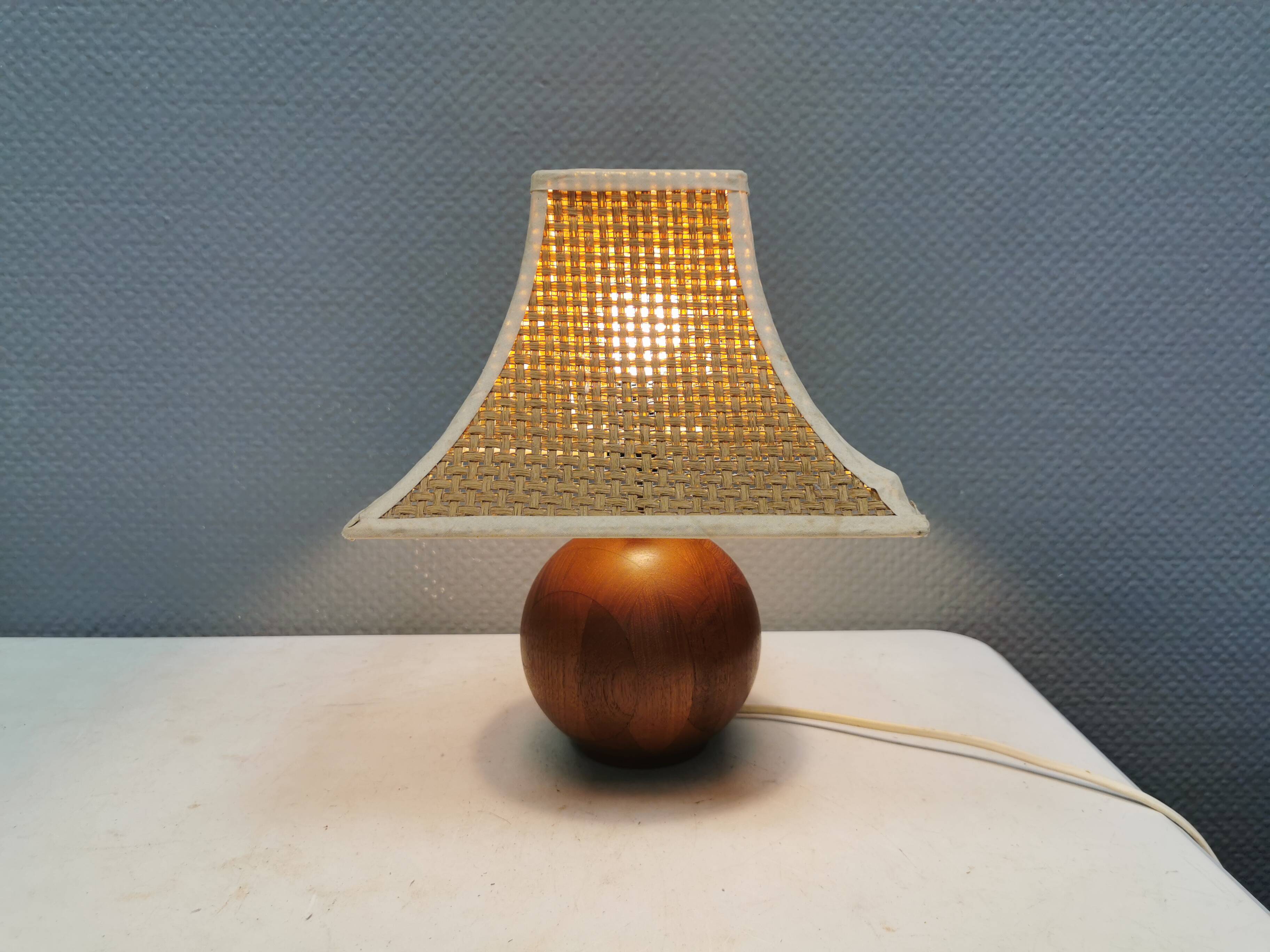Very rare table lamp in turned teak wood with original braided shade. 1970s