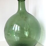 Dame Jeanne ancienne en verre vert à col bagué et ouverture martelée