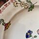 7 hand-painted flowered dinner plates.