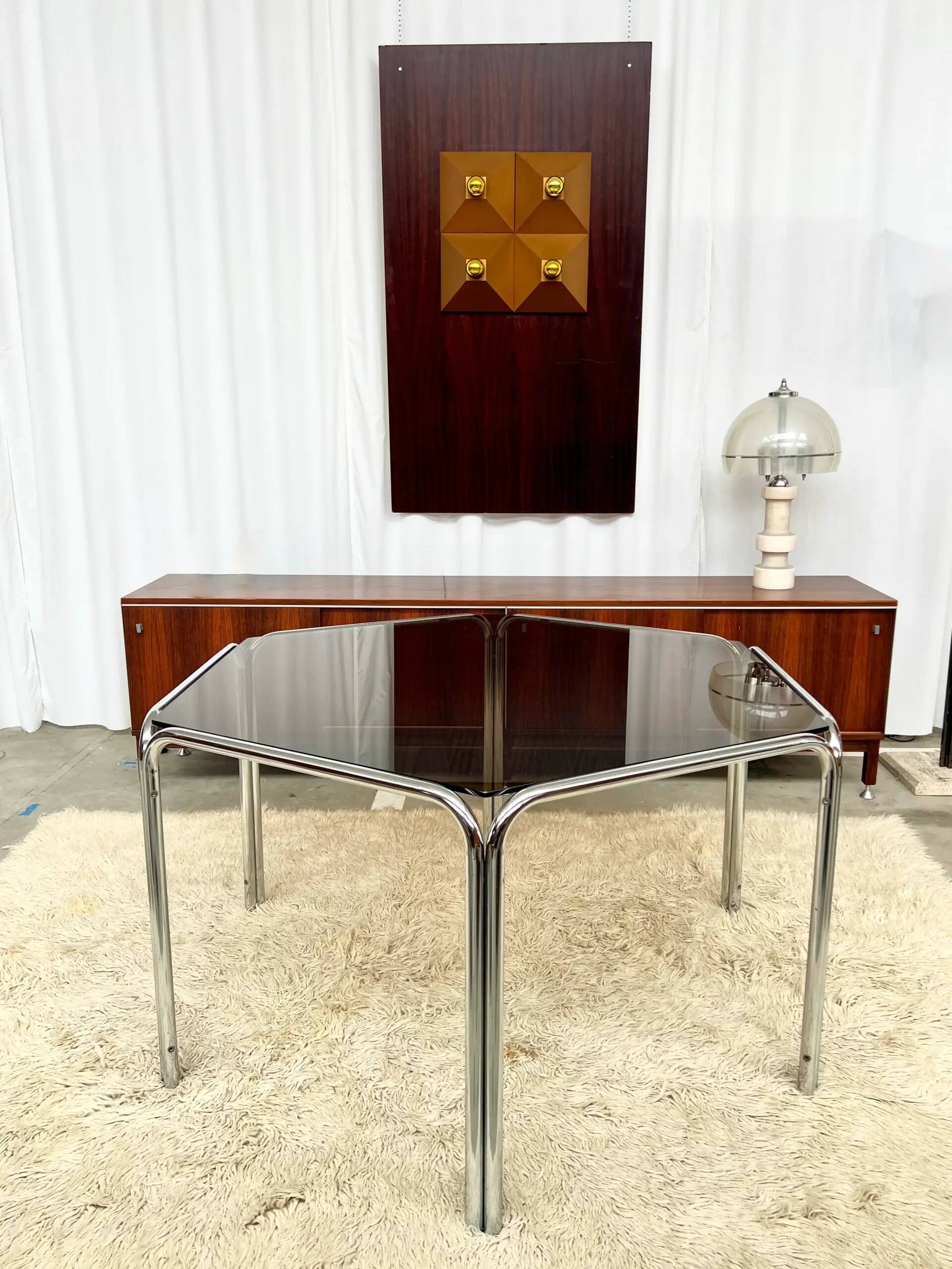 Vintage hexagonal table with smoked glass top and chrome metal structure.