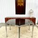 Vintage hexagonal table with smoked glass top and chrome metal structure.