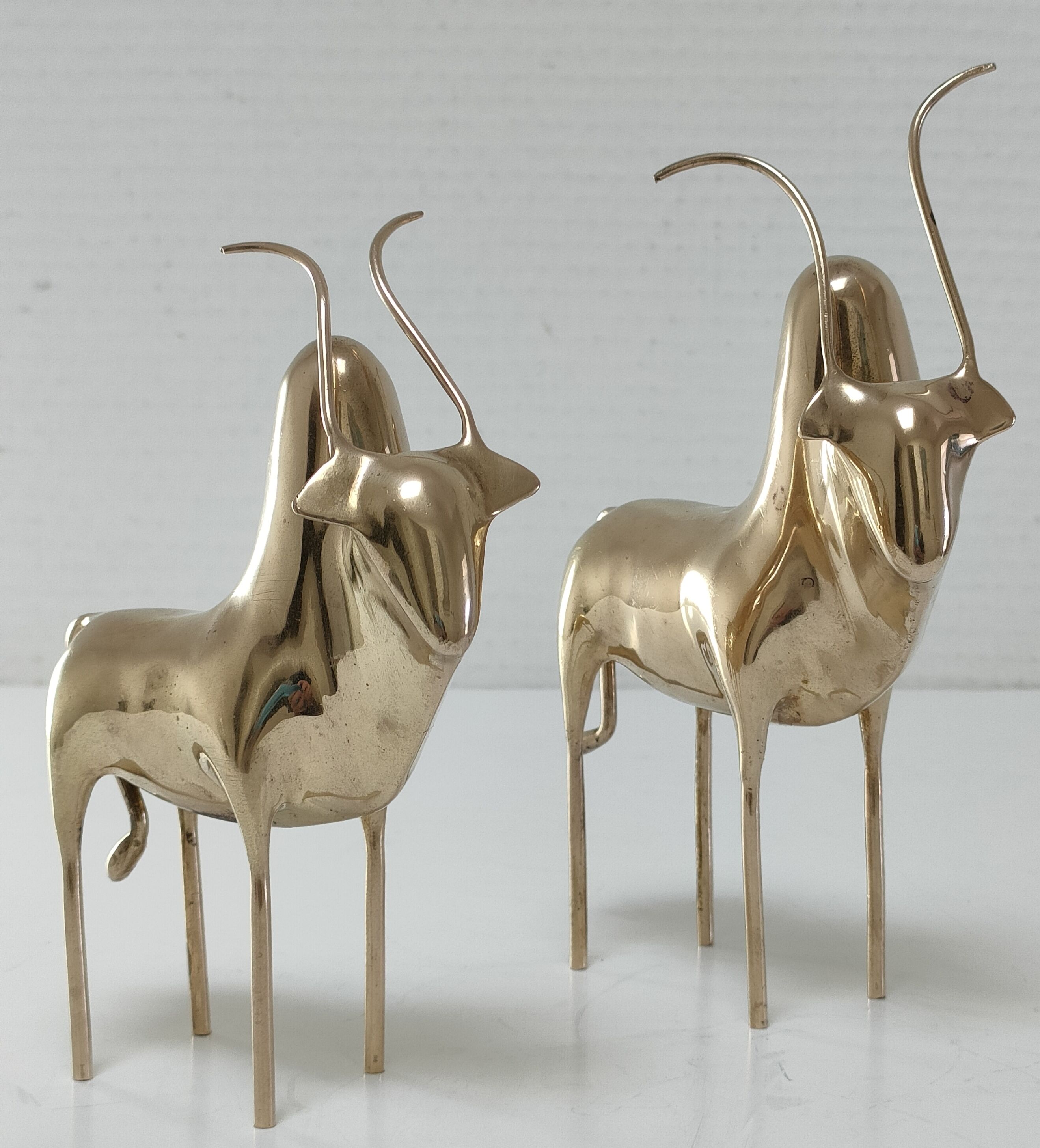 Two stylized zebu with long vintage brass horns