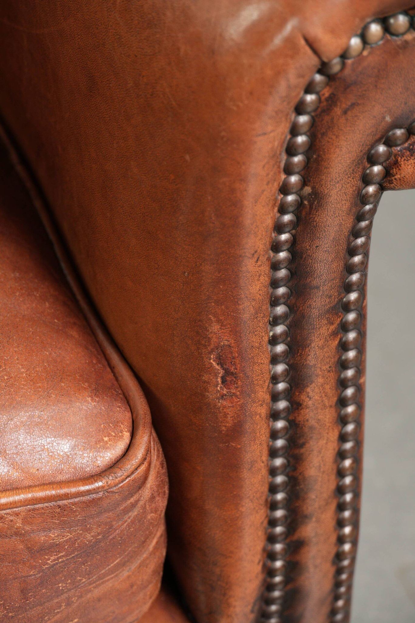 Comfortable vintage sheepskin armchair finished with decorative nails