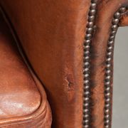 Comfortable vintage sheepskin armchair finished with decorative nails