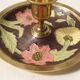 Set of 2 round golden metal candle holders and floral patterns