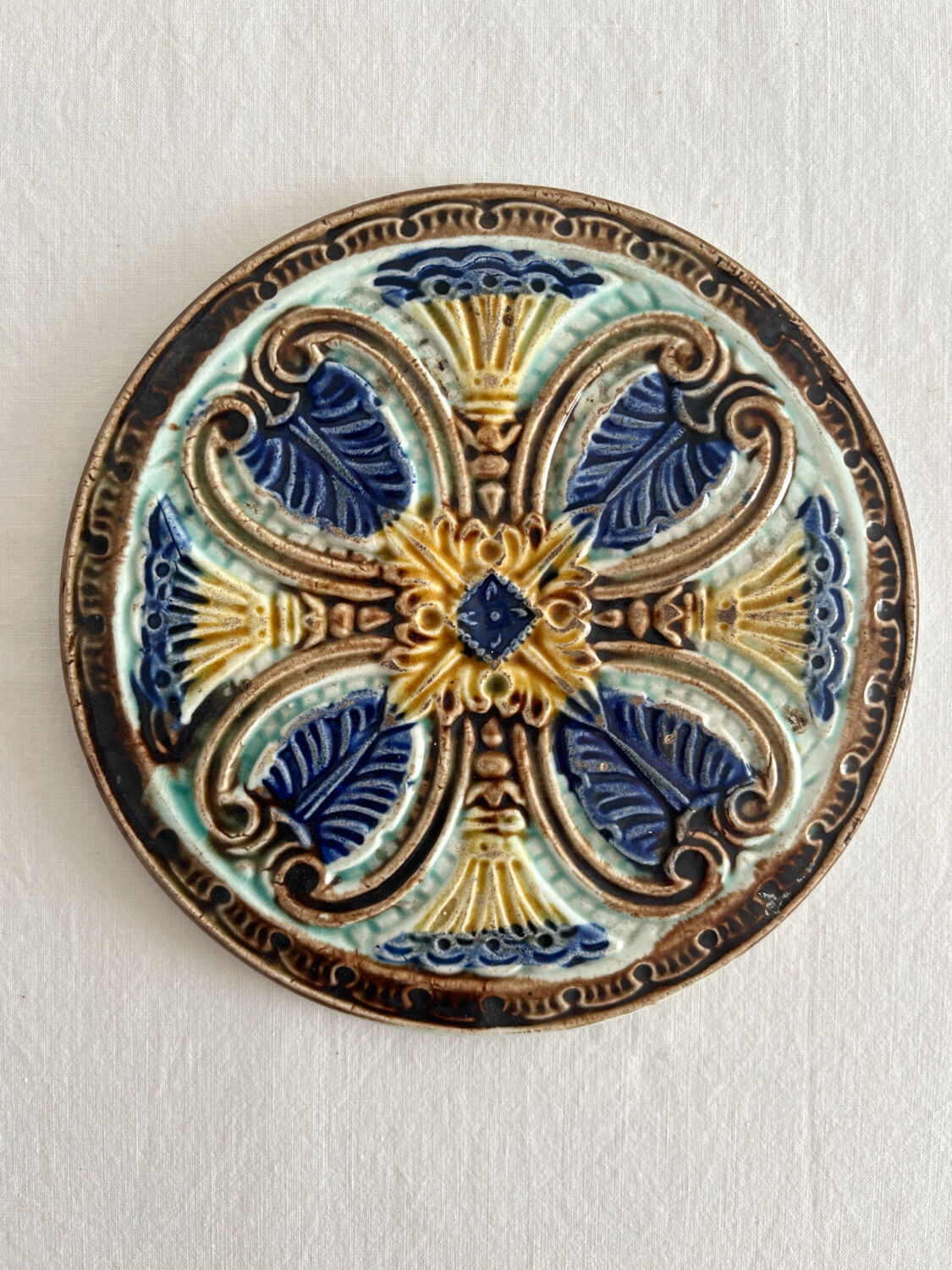 Art Nouveau earthenware bottle coaster/trivet, late 19th/early 20th century