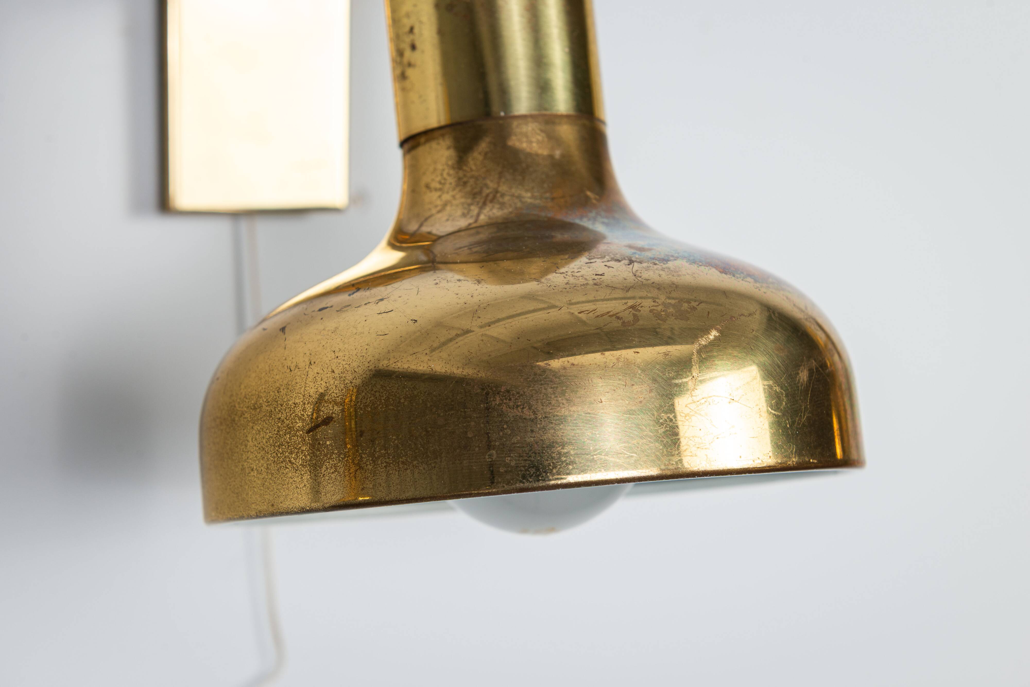 Set of three brass adjustable wall lamps