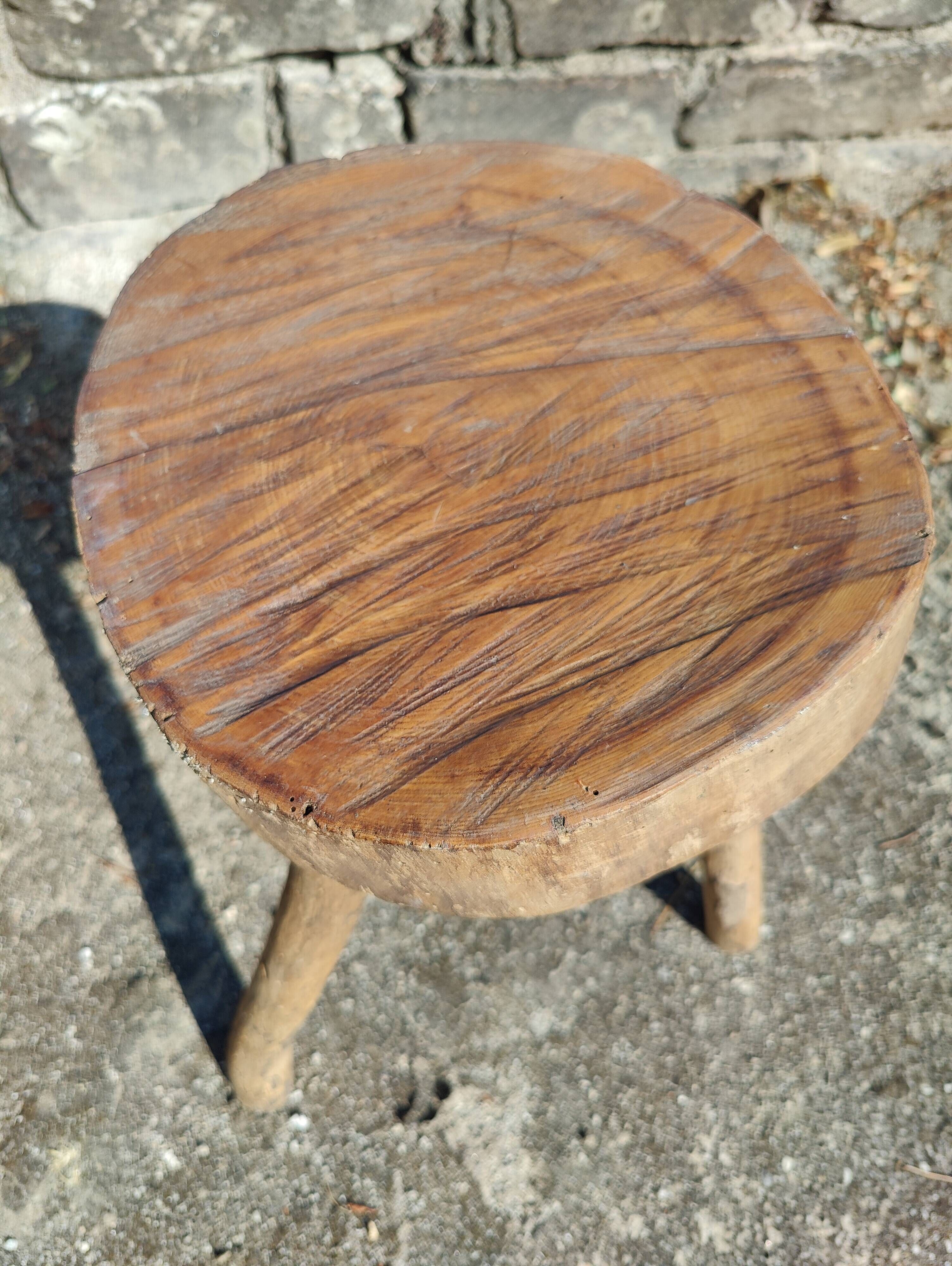Rustic three-legged stool in minimalist wood in the style of Touret.