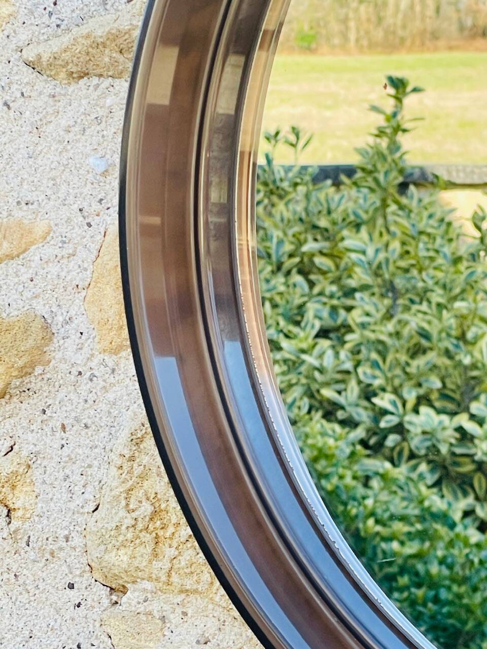 Vintage round smoked plastic mirror, circa 1970s.