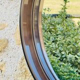 Vintage round smoked plastic mirror, circa 1970s.