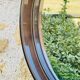 Vintage round smoked plastic mirror, circa 1970s.