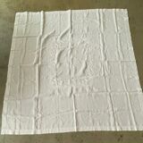 White hand-embroidered square tablecloth at stem stitch