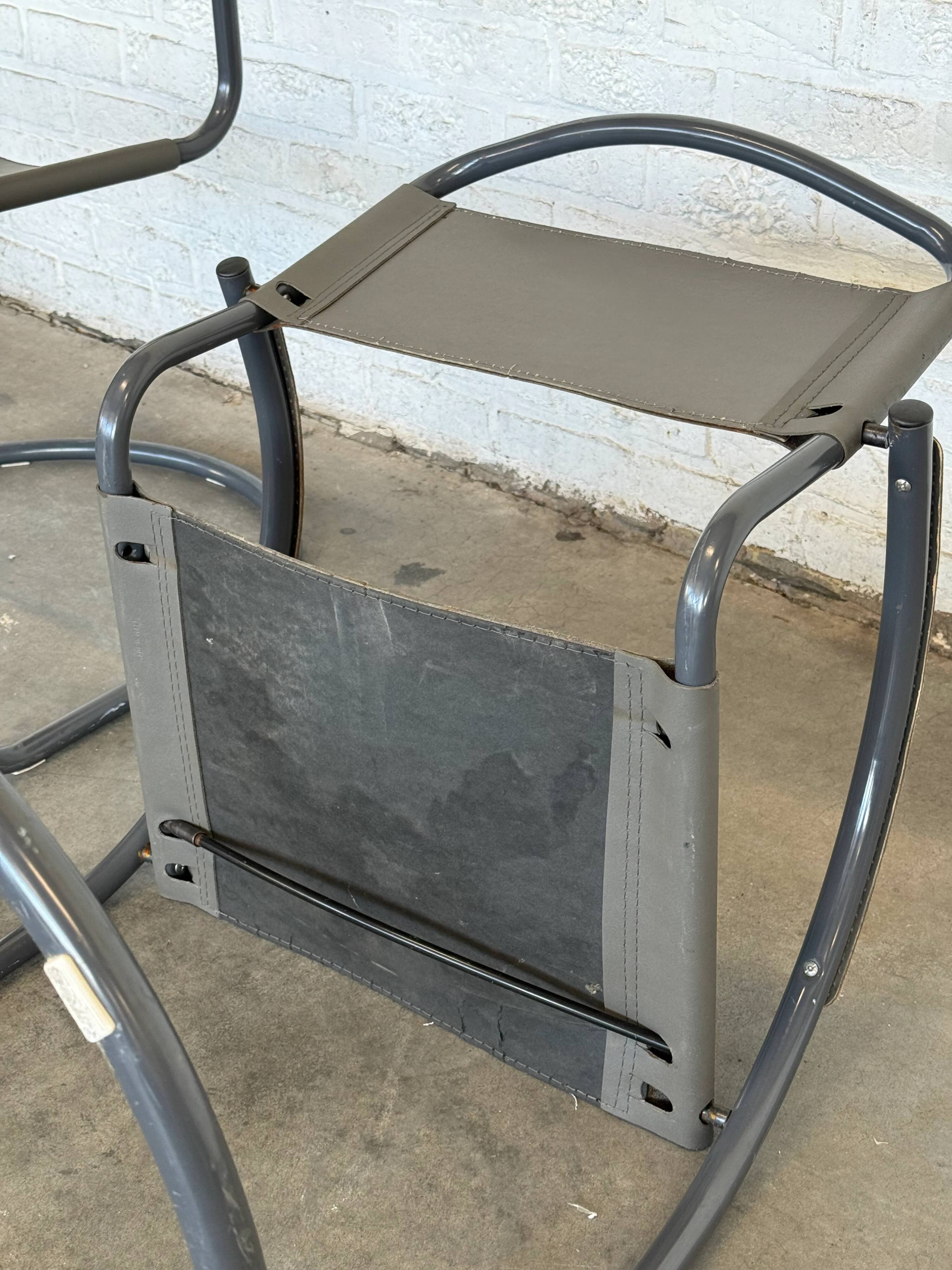 Vintage cantilever lounge chairs — pair, grey leather and tubular steel