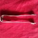 Silver sugar tongs with engraved decoration and lion claws.