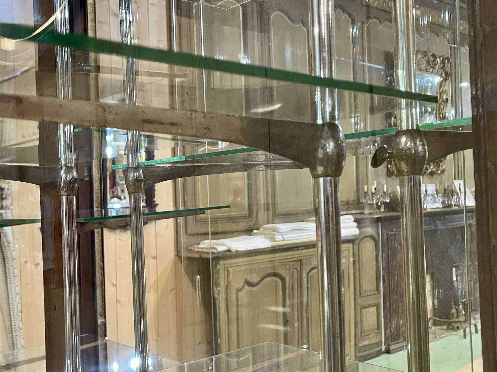 Early 20th-century shop display cabinet in oak with sliding doors.