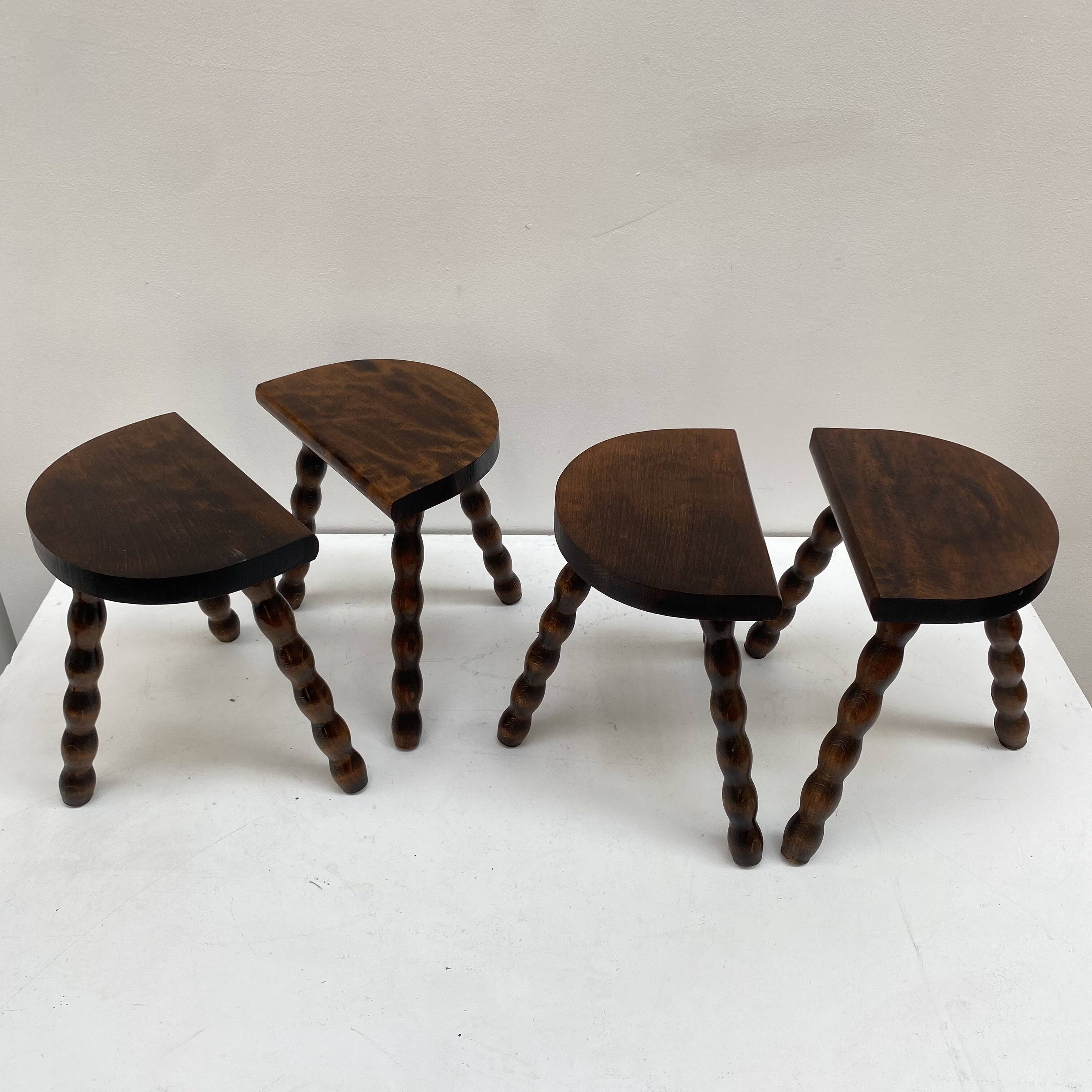 Series of 4 small tripod stools with half-moon seat and beaded turned wood legs