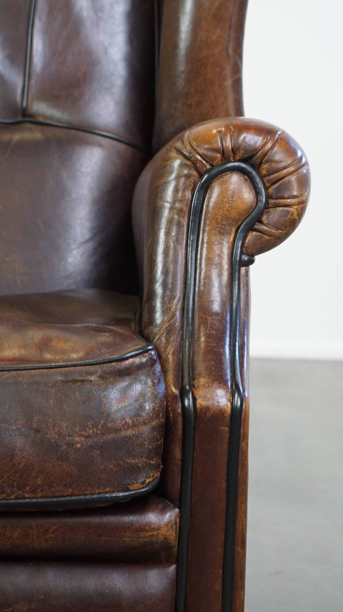 Wing chair made of sheepskin and neatly finished with black piping