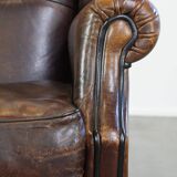 Wing chair made of sheepskin and neatly finished with black piping