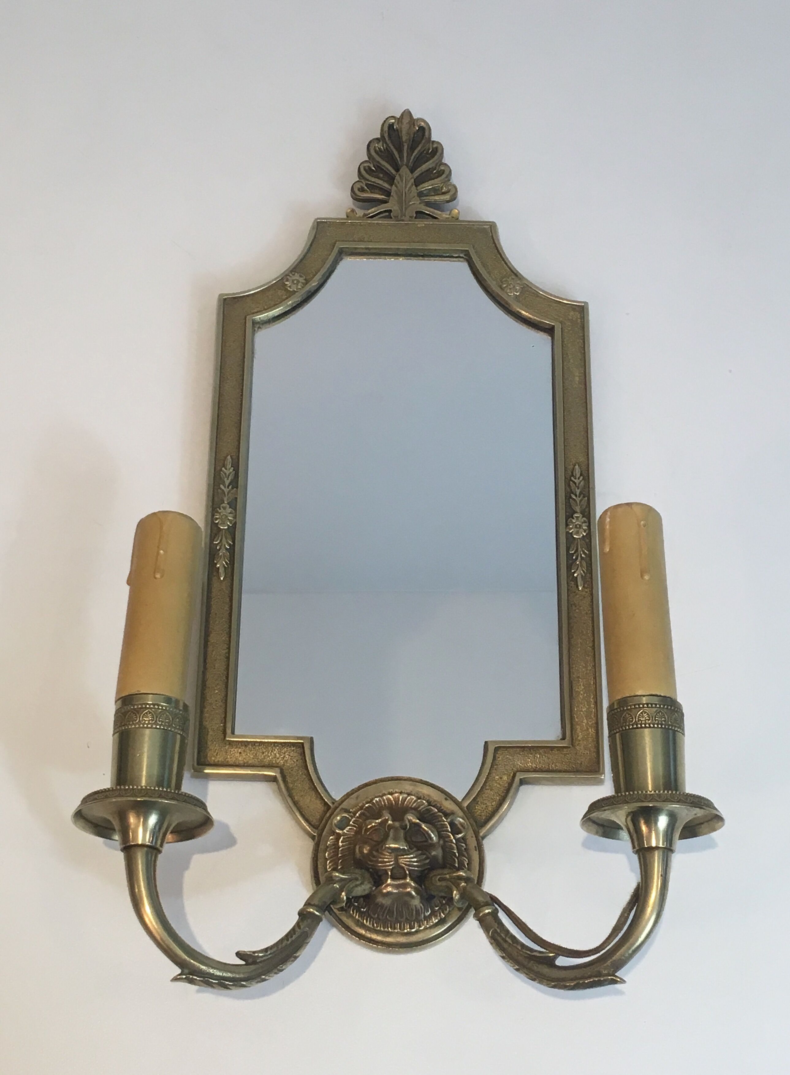 Pair of mirror and bronze wall lamps with lions' heads, french work. around 1940
