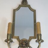 Pair of mirror and bronze wall lamps with lions' heads, french work. around 1940