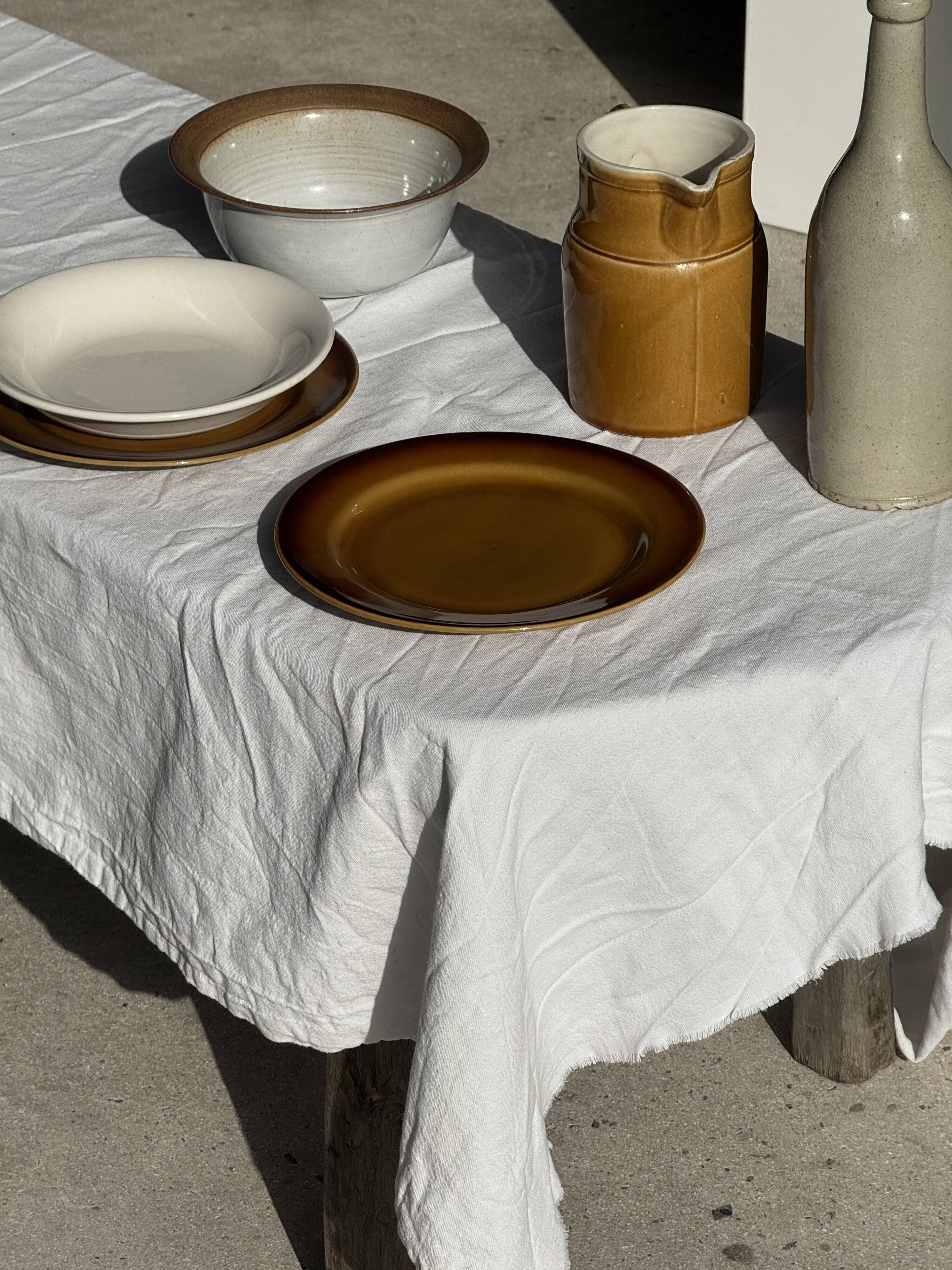 Small thick stoneware bowl with a stylised flower pattern in white on the outside, b