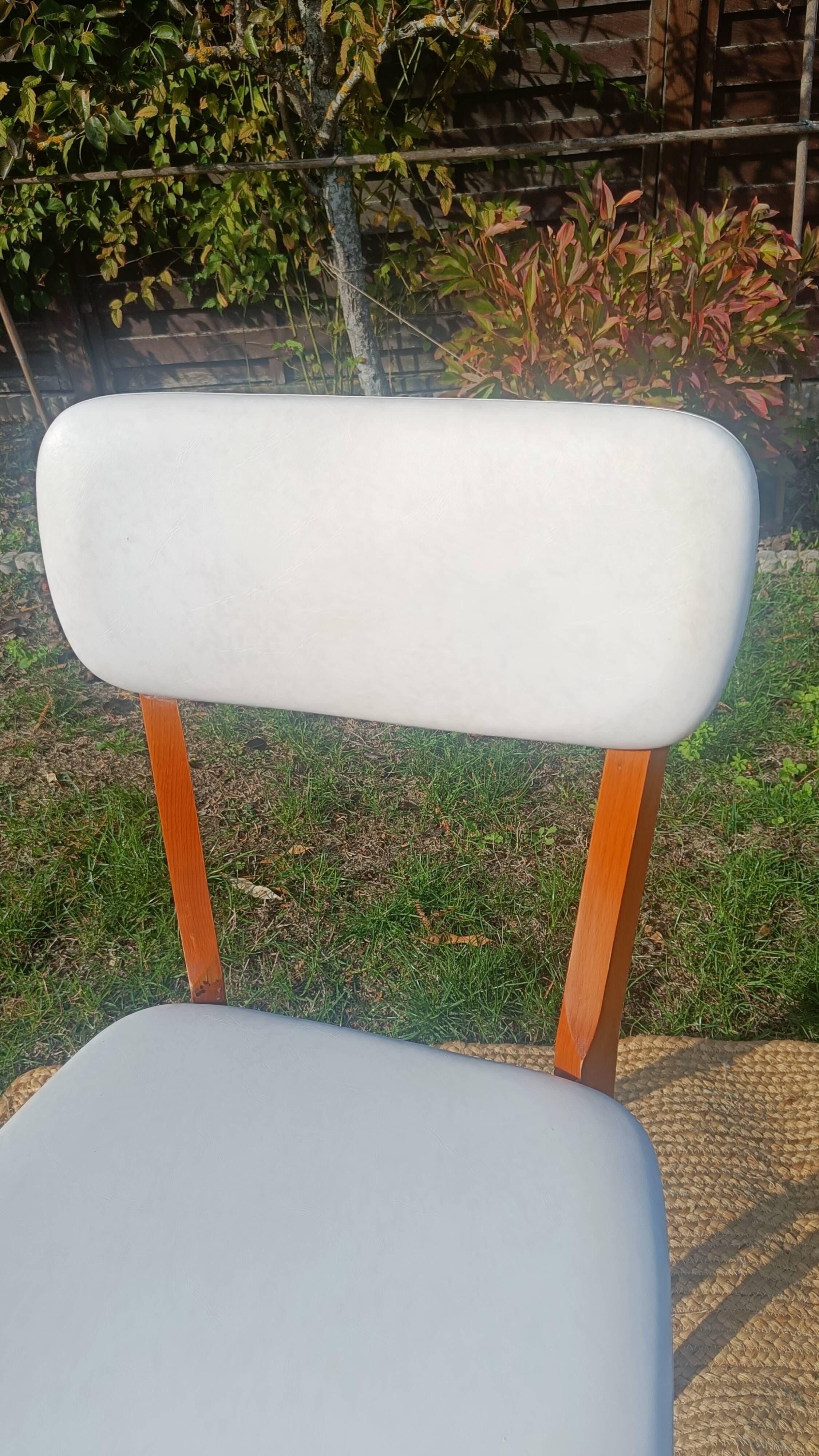 vintage wooden chairs with white faux leather