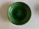 Shallow dish Aegitna on a green glazed earthenware base