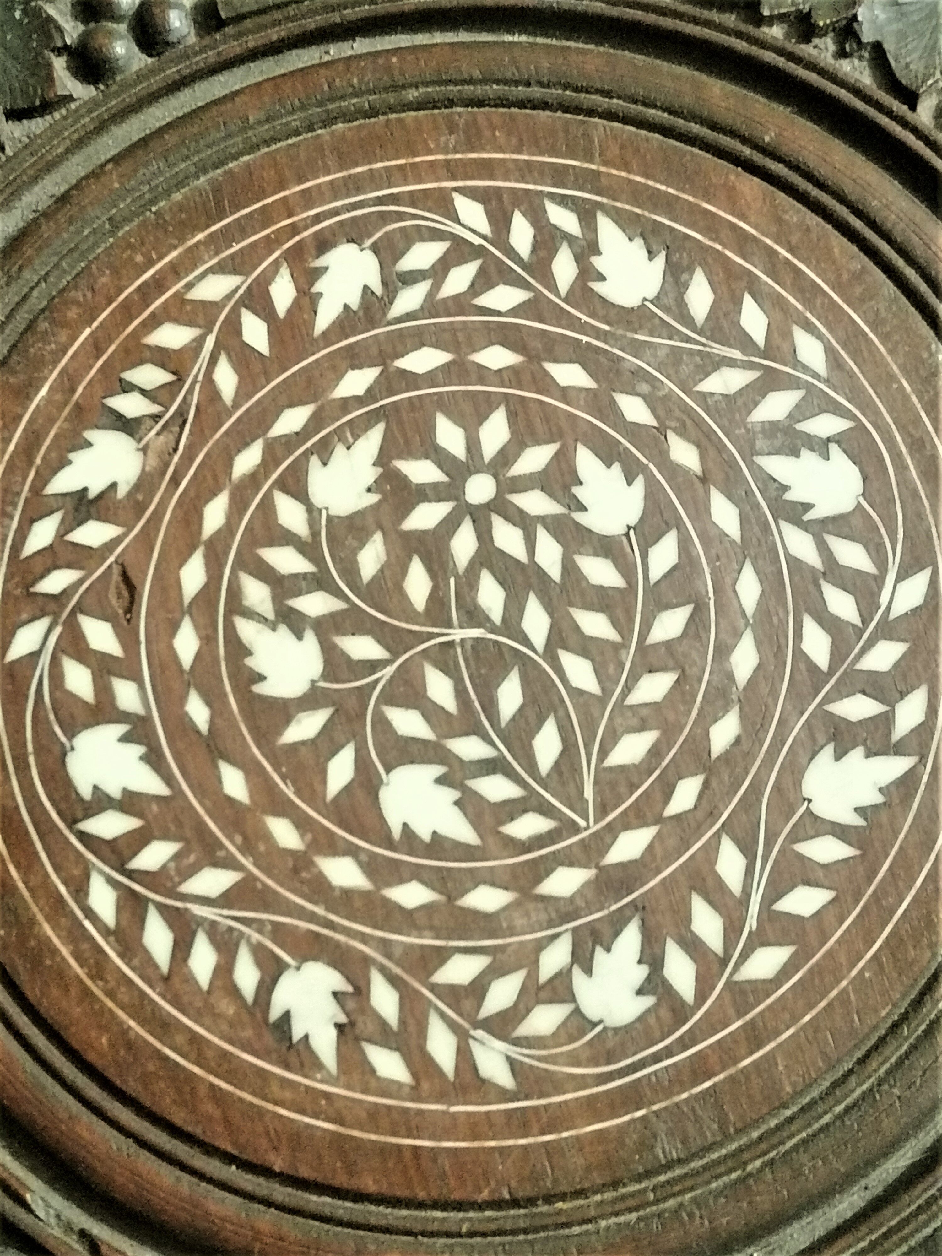 Ancient oriental pedestal table in carved wood