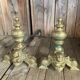 Pair of andirons and grates in cast iron and bronze with gilded grotesques, 17th century