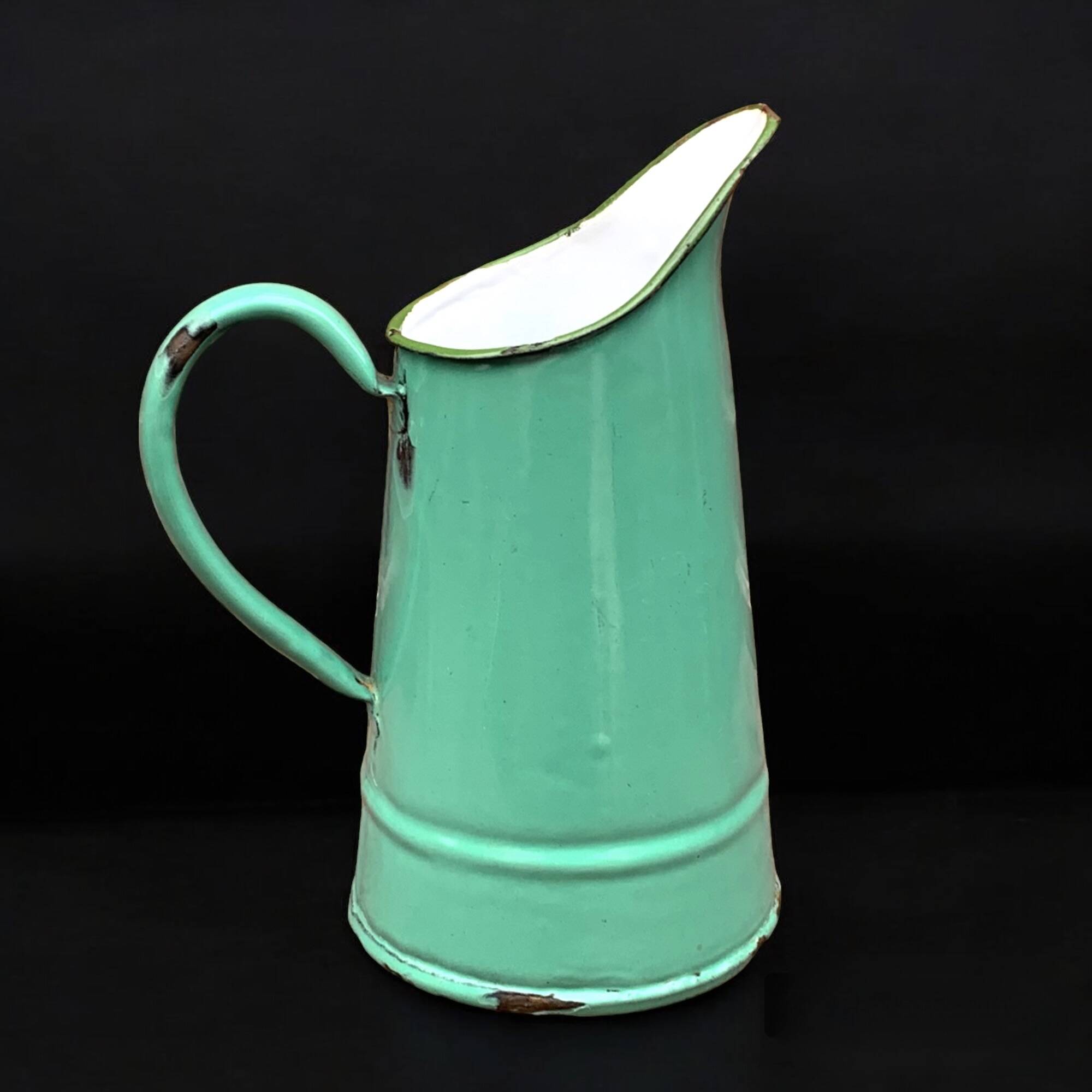 Vintage pitcher in green enameled sheet metal