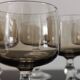 9 white wine glasses on vintage Luminarc smoked black stem
