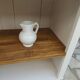 Craft furniture enhanced in pearl gray, shelves and top in raw wood.