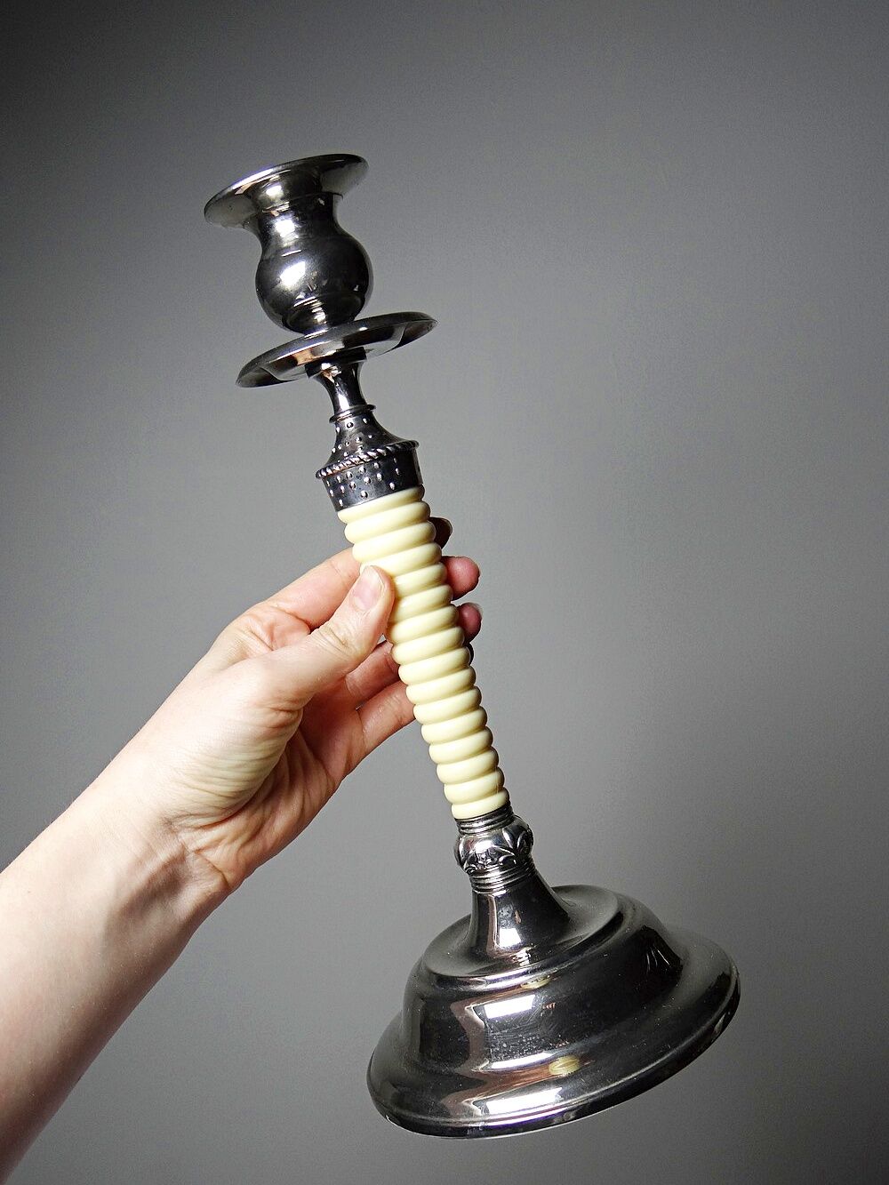 Pair of vintage candlestick holders in silver-plated metal with ivory-style plastic.