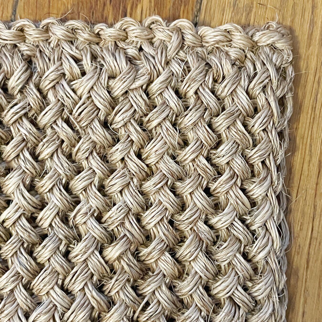 Handmade carpet in natural fiber of knitted palm leaf