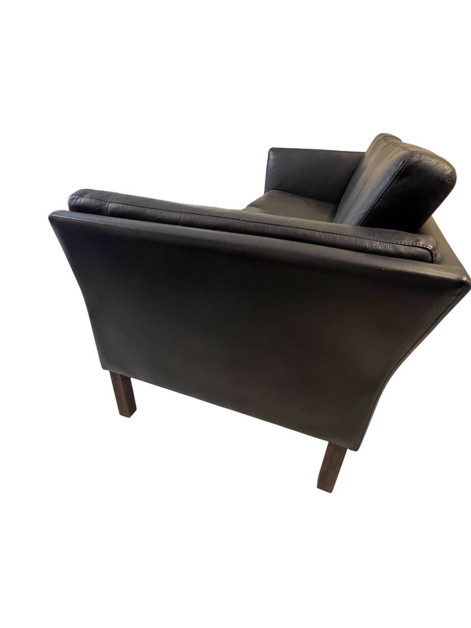 Black leather three-seater sofa