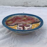Hand-painted plate decorated with a colorful face 60s