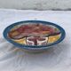 Hand-painted plate decorated with a colorful face 60s