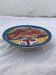 Hand-painted plate decorated with a colorful face 60s