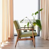 Mid-century modern armchair in olive green bouclé design by H. Lis.